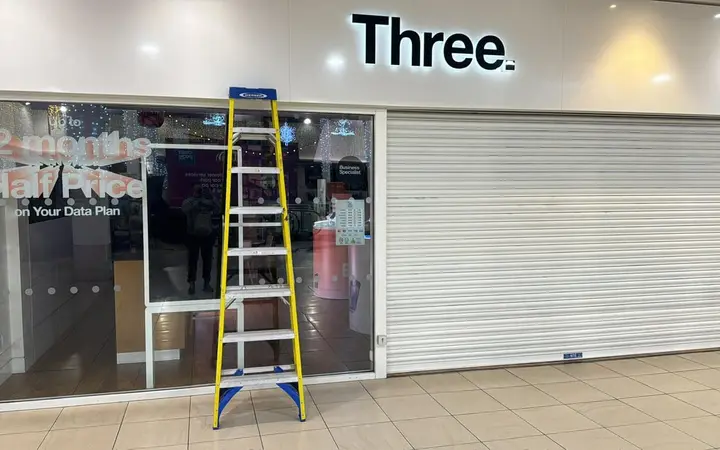 Retail shopfront with glazing and a security shutter in a shopping centre