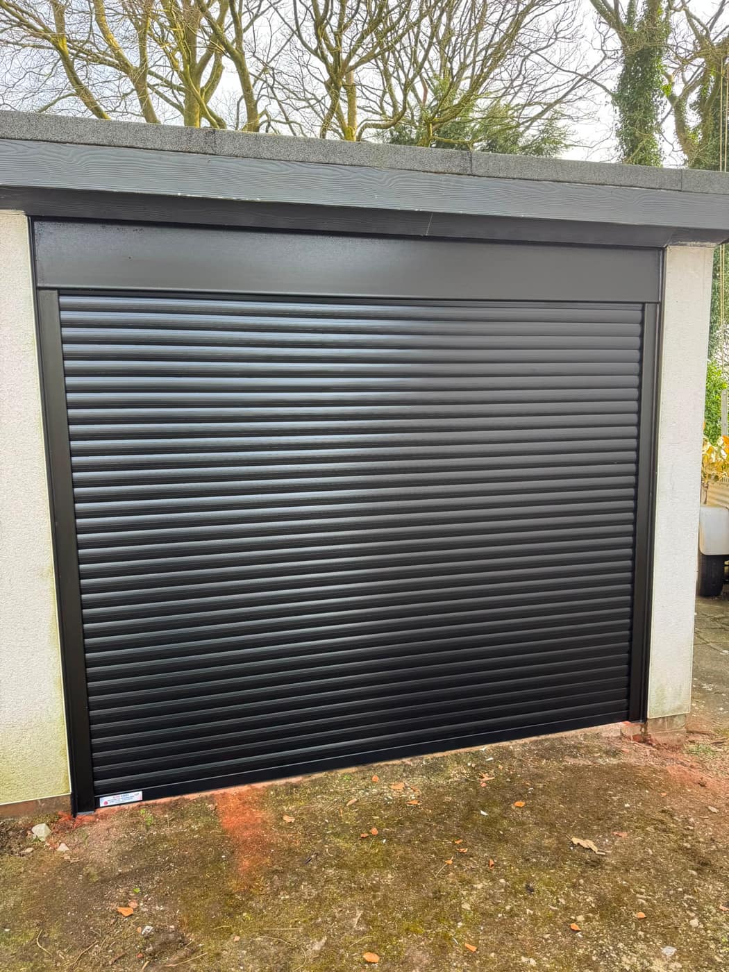 New black roller garage door fitted to a Manchester home