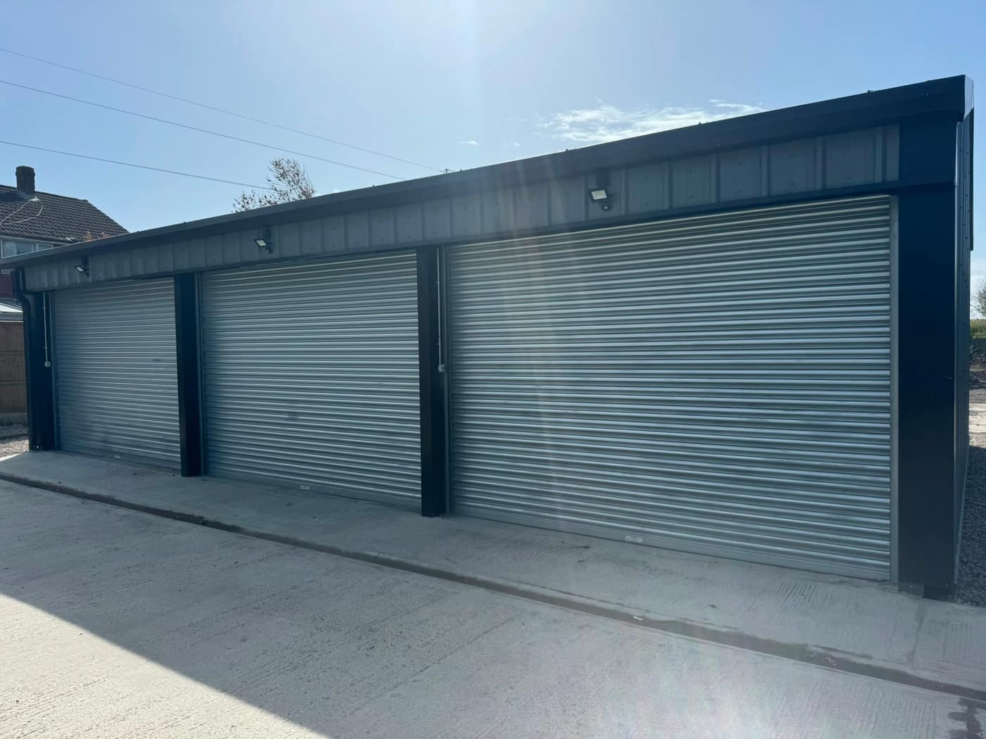 Galvanised roller garage doors on a block of garages near Salford