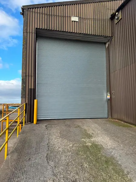 Insulated industrial roller shutter on a steel-clad warehouse
