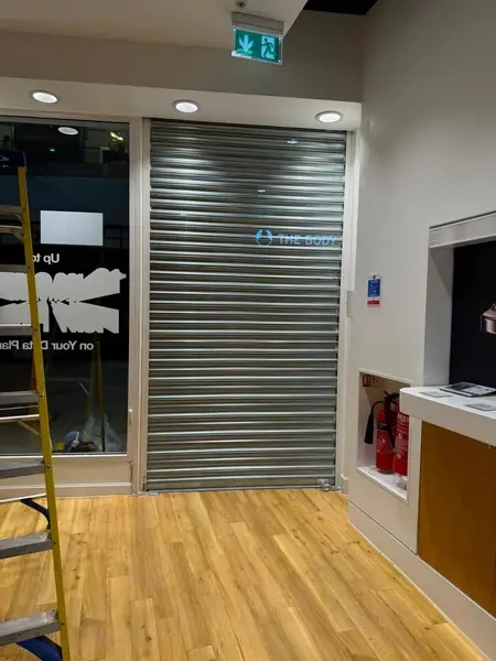Galvanised retail roller shutter fitted inside a store