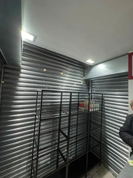 Steel security grille and shutters fitted to a storeroom