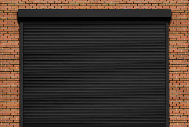 Black roller garage door on a brick garage